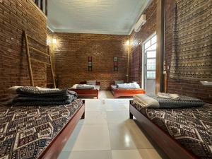a large room with two beds in it at Hakuna Matata homestay Mai Châu in Mai Chau +166 photos