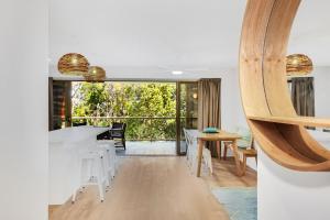a kitchen and dining room with a table and chairs at Lahaina Apartments in Mooloolaba