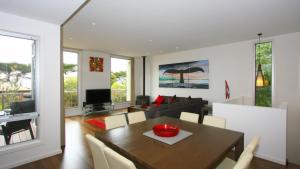 a dining room with a table and a couch at The Lane House in Apollo Bay