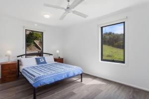 a bedroom with a bed and a window at Blue Sea in Apollo Bay