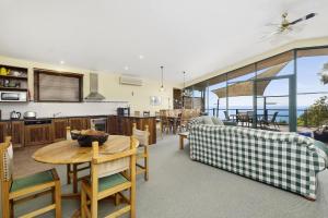 a kitchen and living room with a table and chairs at Cara in Wye River