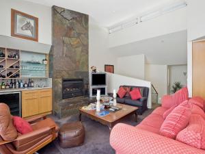 a living room with two couches and a fireplace at Louvres in Wye River