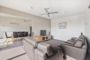 a living room with a couch and a flat screen tv at Amaroo in Marengo