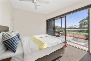 a bedroom with a bed and a large window at Amaroo in Marengo