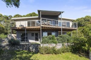a large house with a deck on a hill at Amaroo in Marengo