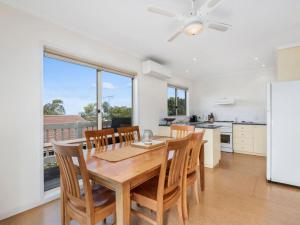 a kitchen and dining room with a table and chairs at Bimbadeen in Apollo Bay