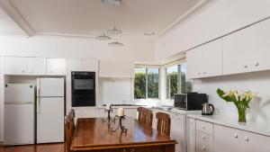 a kitchen with a wooden table and white appliances at Farm House in Johanna