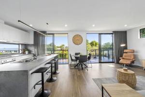 a kitchen and living room with a large clock on the wall at Scenic Estate in Apollo Bay