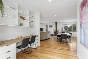 a kitchen and dining room with a table and chairs at Aurora in Apollo Bay