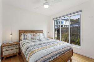 a bedroom with a bed and a large window at Aurora in Apollo Bay