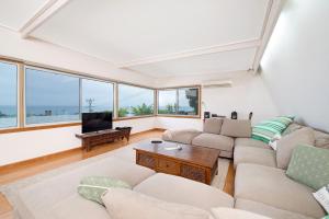 a living room with two couches and a tv at The Dreamery in Apollo Bay +1 photo