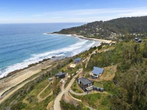an aerial view of a house next to the ocean at Iluka Blue in Wye River