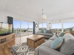 a living room with a couch and a tv at Art House in Apollo Bay