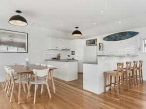 a kitchen and dining room with a table and chairs at Art House in Apollo Bay