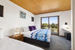 a bedroom with two beds and a window at Manta Ray One in Apollo Bay