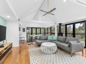 a living room with a couch and a table at Gulah in Wye River