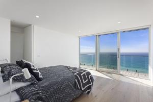a bedroom with a bed with a view of the ocean at Southpoint -Brand new home, oceanfront views in Wye River