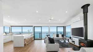 a kitchen and living room with a view of the ocean at The Blue House in Wye River