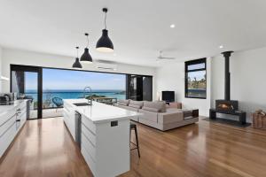 a kitchen and living room with a view of the ocean at The Cube in Wye River