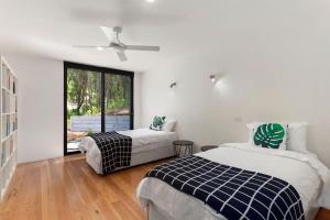 a bedroom with two beds and a window at The Cube in Wye River