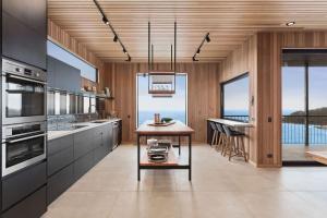 a kitchen with a table and a view of the ocean at At Wye Eyrie II in Wye River