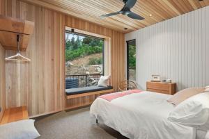 a bedroom with a bed and a window with a balcony at At Wye Eyrie II in Wye River