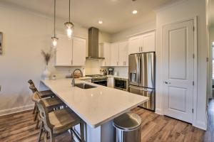 a kitchen with white cabinets and a large island at Santa Rosa Beach Vacation Rental Near Ocean! in Santa Rosa Beach