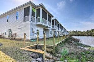 a large house with a dock next to a river at Santa Rosa Beach Vacation Rental Near Ocean! in Santa Rosa Beach