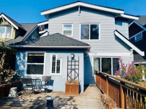 a blue house with a deck with chairs on it at Cozy Dunbar 3 Beds Home w/ Views in Vancouver