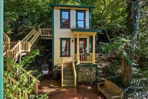 a tiny house with a staircase leading up to it at The Peabody House in Eureka Springs