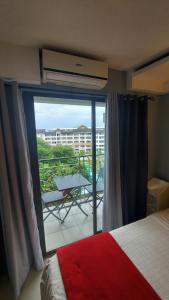 a bedroom with a bed and a balcony with a view at 1bedroom one oasis condo fullyfurnished in Davao City +75 photos