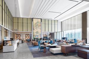 a rendering of a lobby with tables and chairs at Changzhou Marriott Hotel Jintan in Changzhou