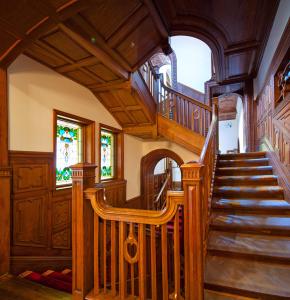 a wooden spiral staircase in a house with wooden ceilings at Shanghai Hengshan Moller Villa Hotel in Shanghai