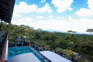 a view from the balcony of a resort with a swimming pool at Capital O 887 Green Hill Hotel And Convention Center in Jember