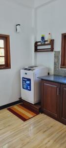 a kitchen with a stove in the corner of a room at Kumudu Home Stay 