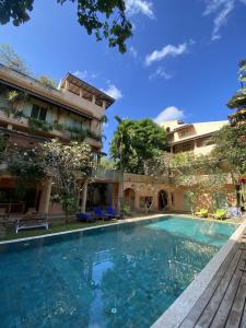 a swimming pool in front of a building at Casa Maria in Mirissa