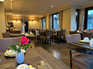 a dining room with tables and chairs and a restaurant at Hotel Atlas in Zeebrugge