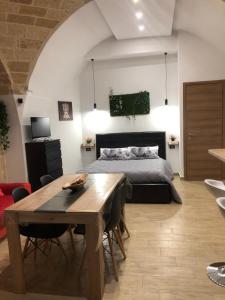 a bedroom with a bed and a table and a dining room at Casa Sipontina in Barletta +25 photos