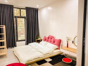 a bedroom with a bed with a pink headboard and a window at KS - Homestay MyLan in Lạng Sơn