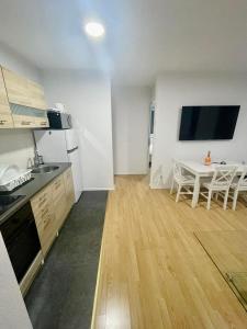 a kitchen with a table and a small kitchen with a dining room at MURIC Apartman 8 in Ljubljana