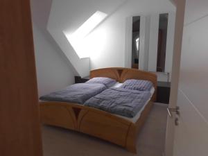 a bedroom with a bed in a white room at Haus Horst - Schwerin-Görries in Klein Rogahn