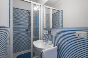 a bathroom with a sink and a glass shower at B&B Ondina in Rome