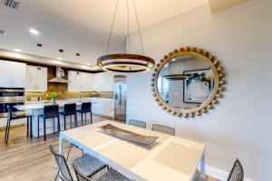 a kitchen and dining room with a table and a mirror at Penthouse Sweet in St Pete Beach
