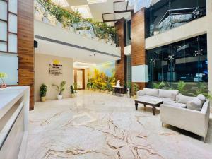 a lobby with a couch and a table in a building at SJ PARADISE in Dehradun