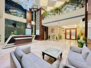 a lobby with couches and a table in a building at SJ PARADISE in Dehradun