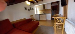a living room with a couch and a kitchen at Villa La Kola Krusevo in Kruševo