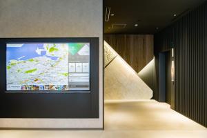a projection screen with a map on a wall at Prince Smart Inn Naha in Naha
