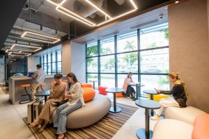 a group of people sitting in an office lobby at Prince Smart Inn Naha in Naha