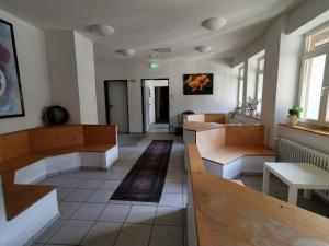 a waiting room with benches and tables in a building at Europäisches Gäste- und Seminarhaus in Todtmoos