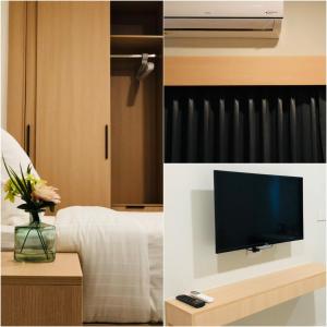 una camera d'albergo con TV e una camera con letto di AT Apartment a Hat Yai